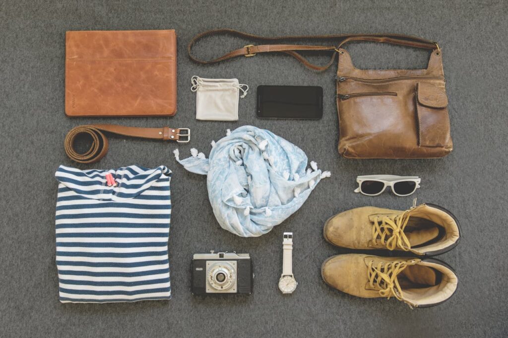 pexels photo 322207 Vintage travel essentials flat lay with leather bags, shoes, camera, and clothing.